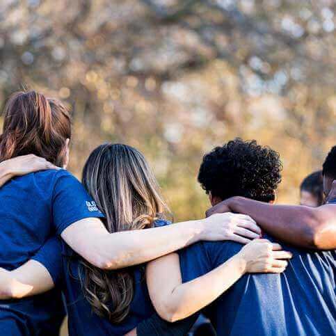 Volunteers hugging in a circle